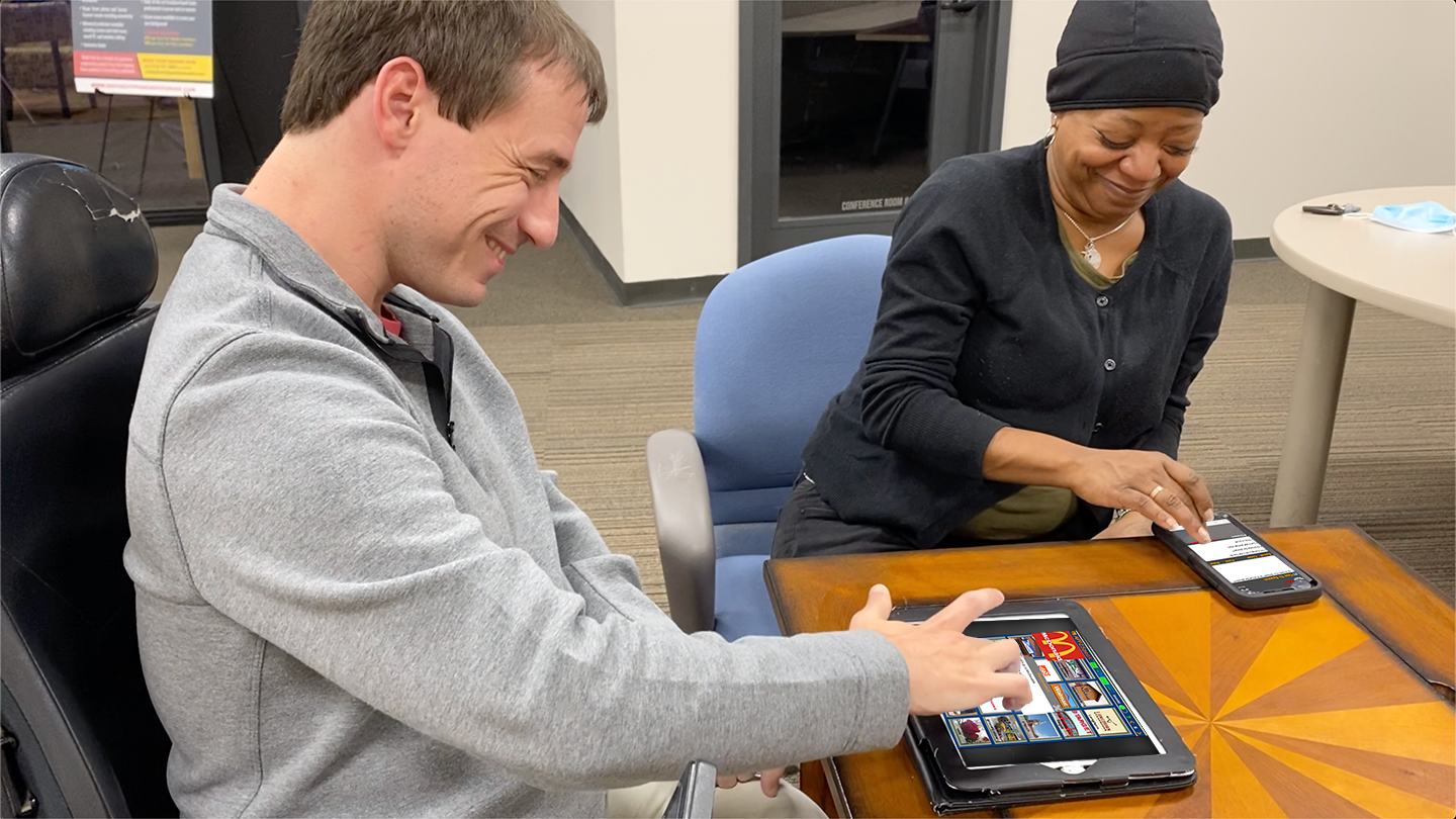 two adults using an app for speech assistance