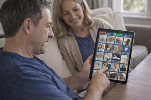 Adult using an AAC app on an iPad to communicate at home