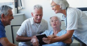 Older adult using a tablet to communicate with family and a healthcare professional